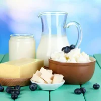 fresh-dairy-products-with-blueberry-wooden-table-natural-background_392895-396200